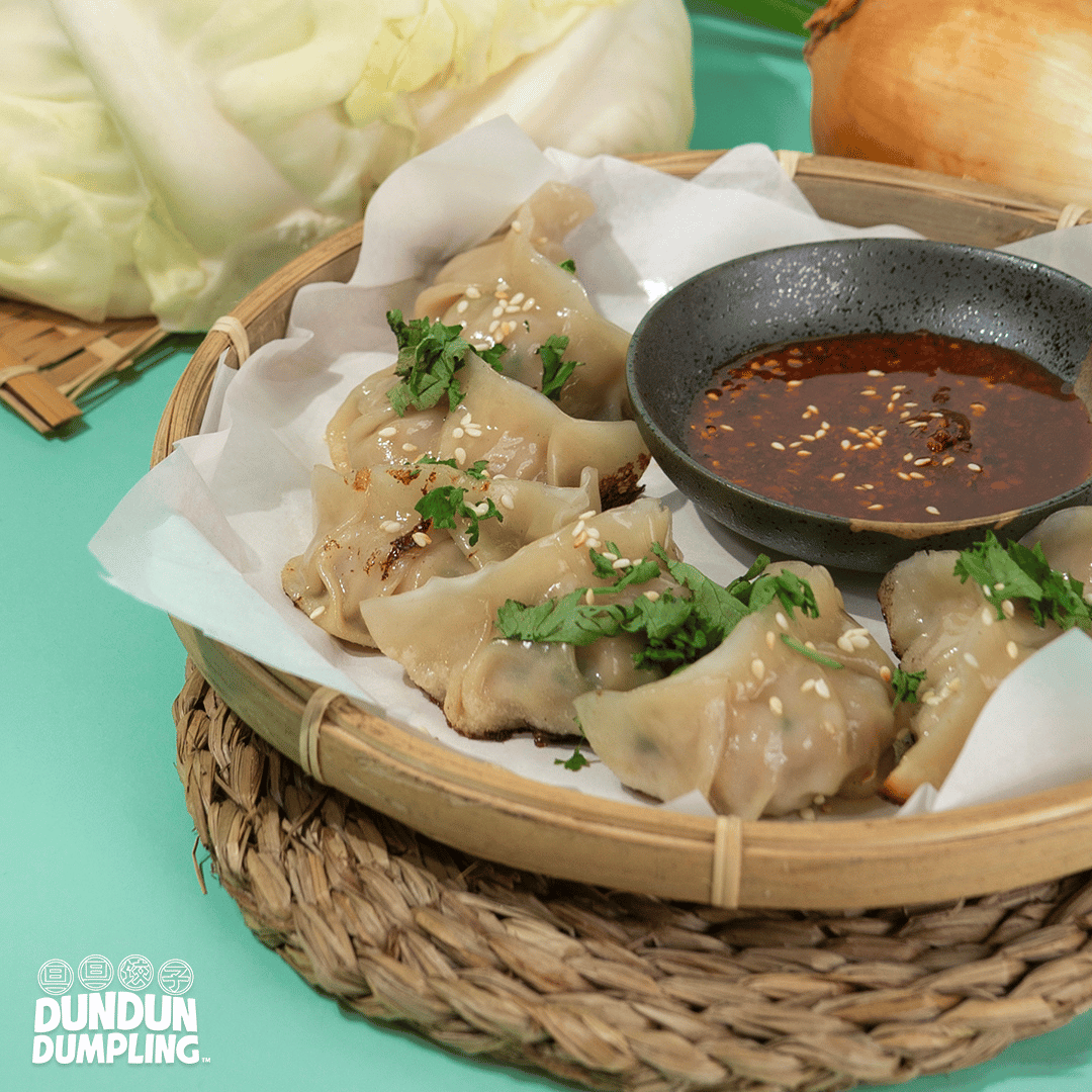 pork w cabbage dumpling. cooked dumpling. from side